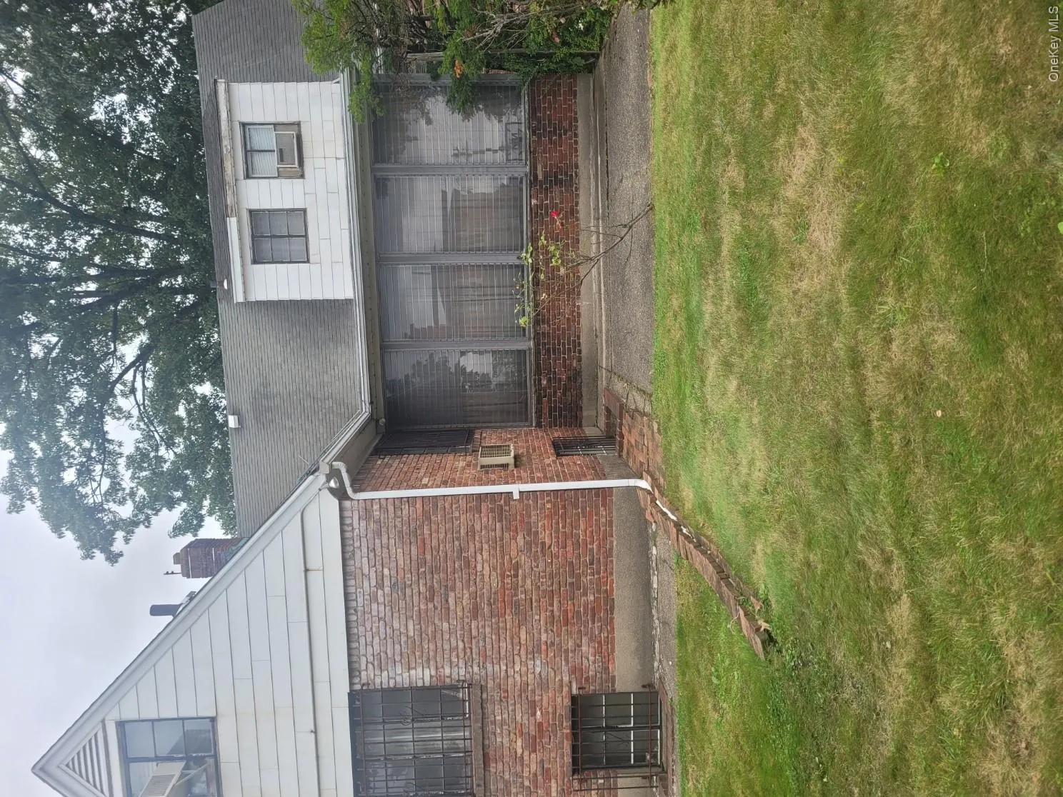 Brick and siding exterior with a pitched roof and enclosed patio Brick and siding exterior with a pitched roof and enclosed patio