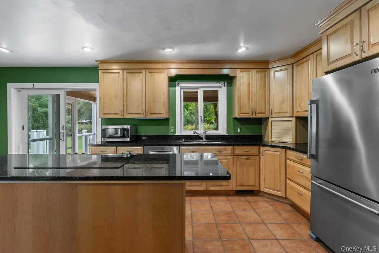 Custom designed kitchen with wood cabinetry and granite counter tops Custom designed kitchen with wood cabinetry and granite counter tops