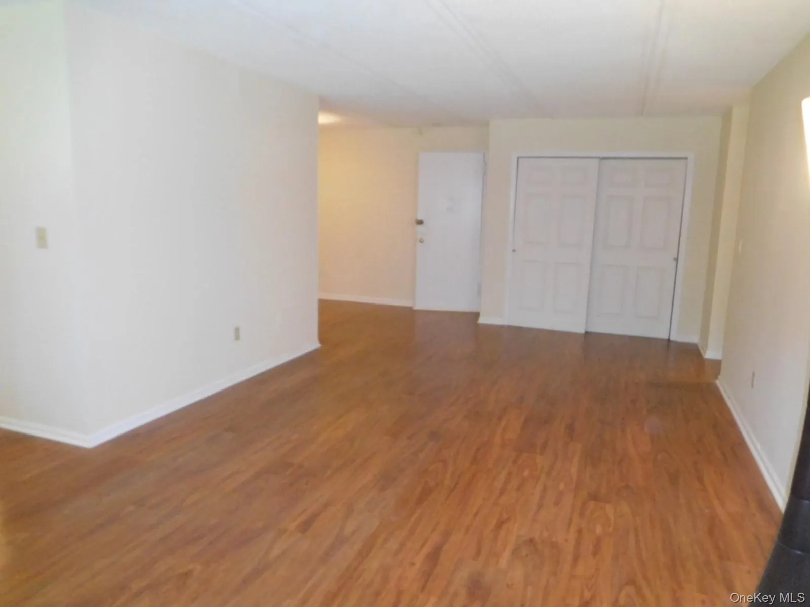 Opposite view of Living room w/beautiful Laminate flooring Opposite view of Living room w/beautiful Laminate flooring