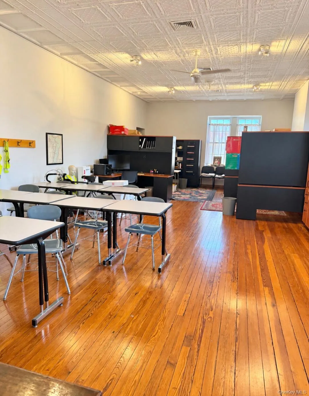 Hardwood flooring, patterned ceiling, ceiling fan, track lighting, and window with natural light Hardwood flooring, patterned ceiling, ceiling fan, track lighting, and window with natural light