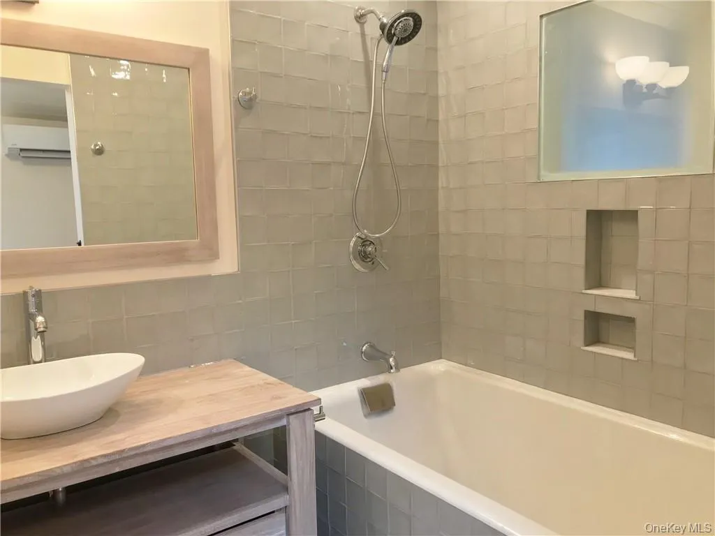 A great feature is the cast iron 5.5' soaking tub/shower surrounded by custom tile A great feature is the cast iron 5.5' soaking tub/shower surrounded by custom tile