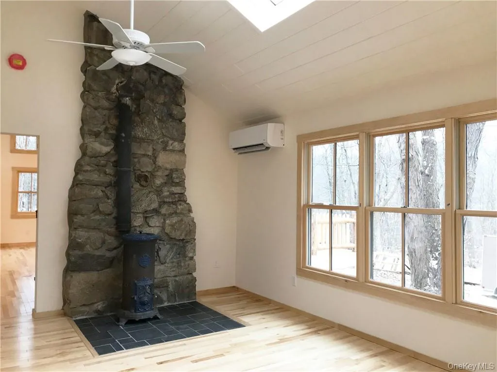 The bedroom with antique stove, separate HVAC unit, featuring fan, full bath and wlk-in closet The bedroom with antique stove, separate HVAC unit, featuring fan, full bath and wlk-in closet