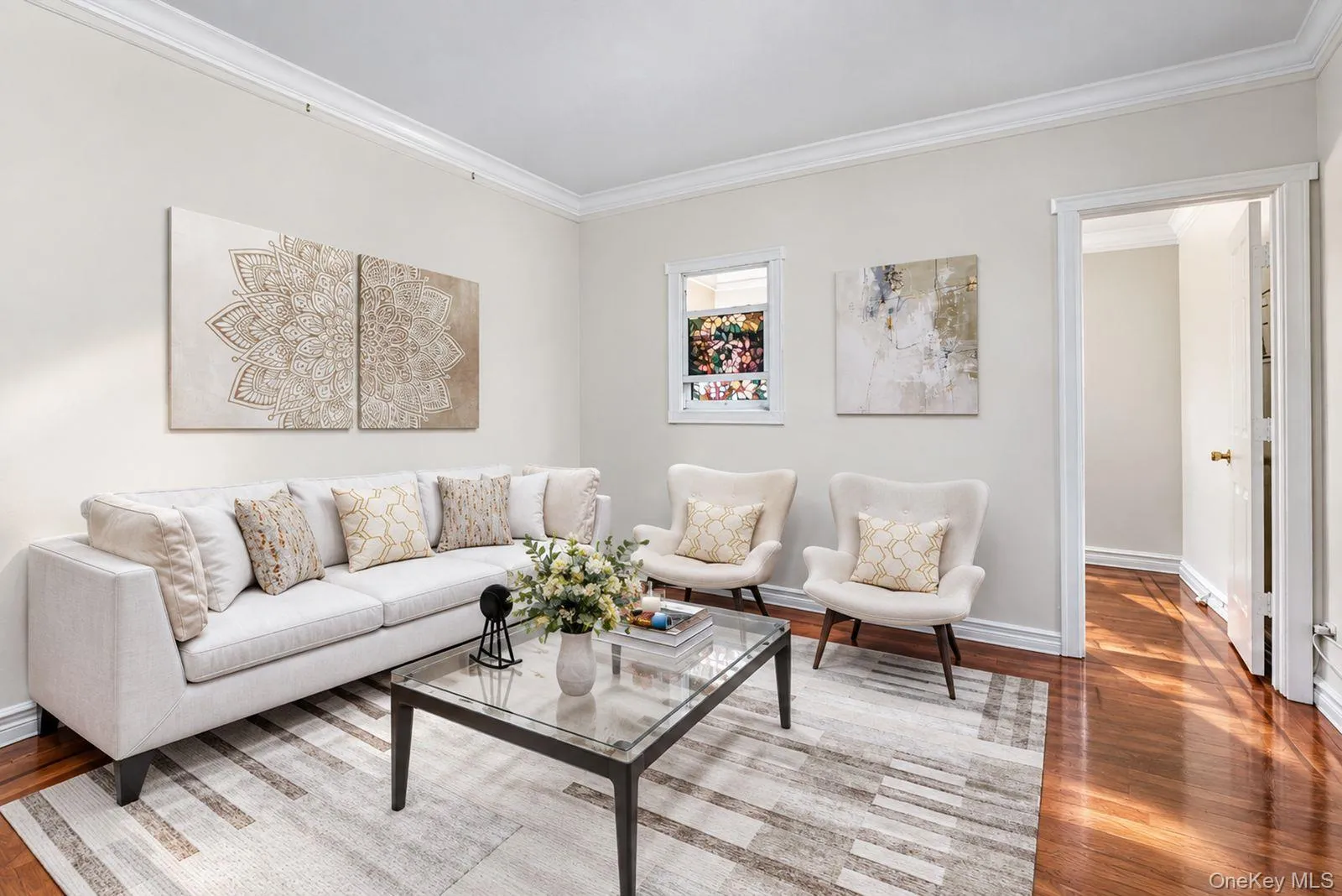 Hardwood flooring, crown molding, white trim, recessed window, and a cased opening Hardwood flooring, crown molding, white trim, recessed window, and a cased opening