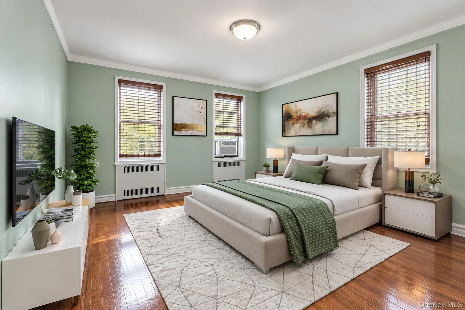 Hardwood flooring, light green painted walls, crown molding, and multiple windows with blinds Hardwood flooring, light green painted walls, crown molding, and multiple windows with blinds
