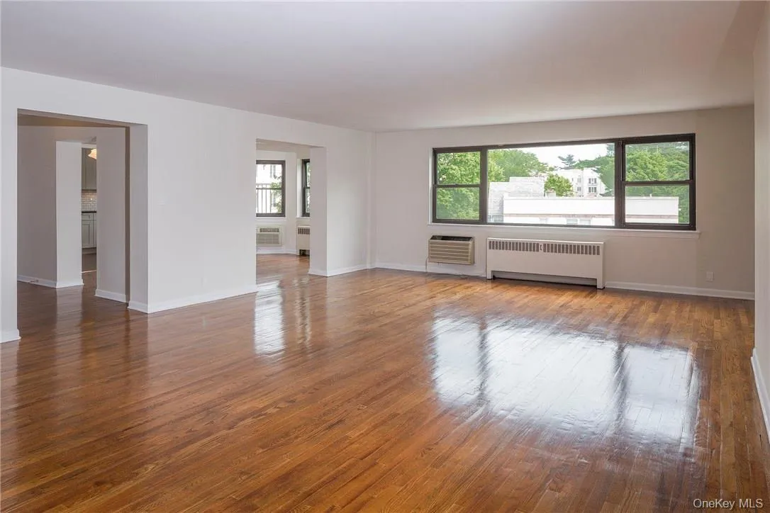 Huge living room opens to dining room and entry way to apartment Huge living room opens to dining room and entry way to apartment