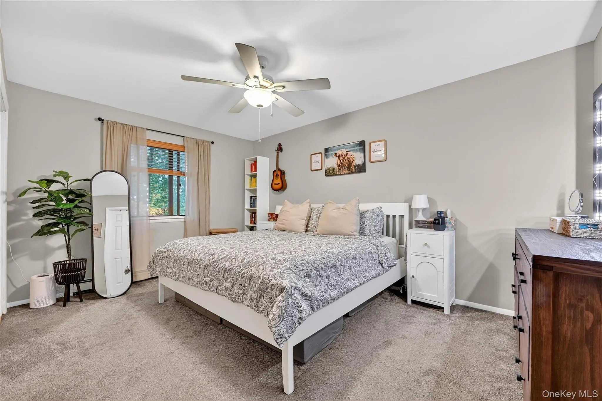 Bedroom with light colored carpet and a ceiling fan Bedroom with light colored carpet and a ceiling fan