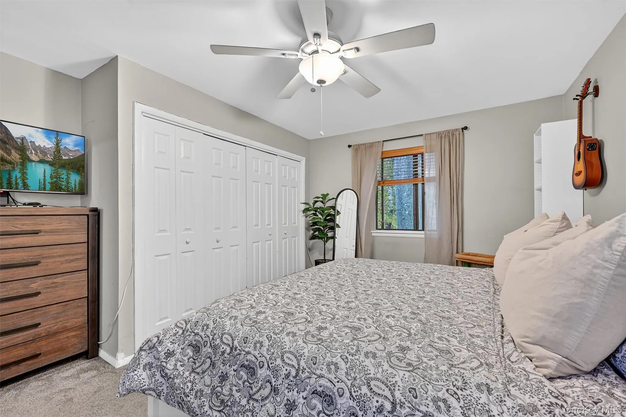 Bedroom with light carpet, a closet, and ceiling fan Bedroom with light carpet, a closet, and ceiling fan
