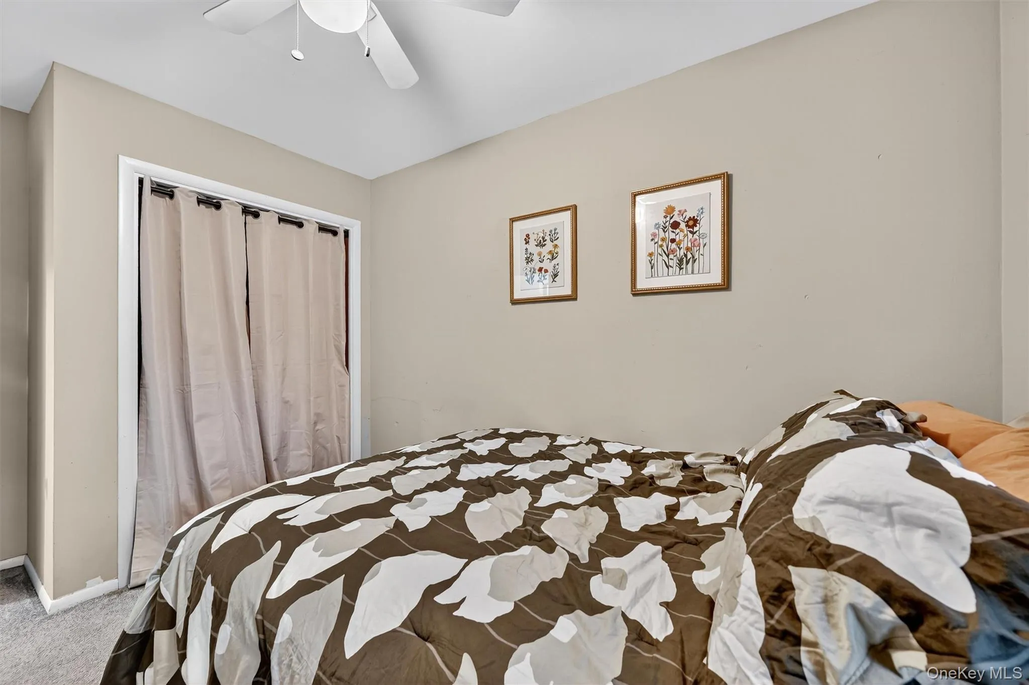 Bedroom featuring carpet floors and a ceiling fan Bedroom featuring carpet floors and a ceiling fan