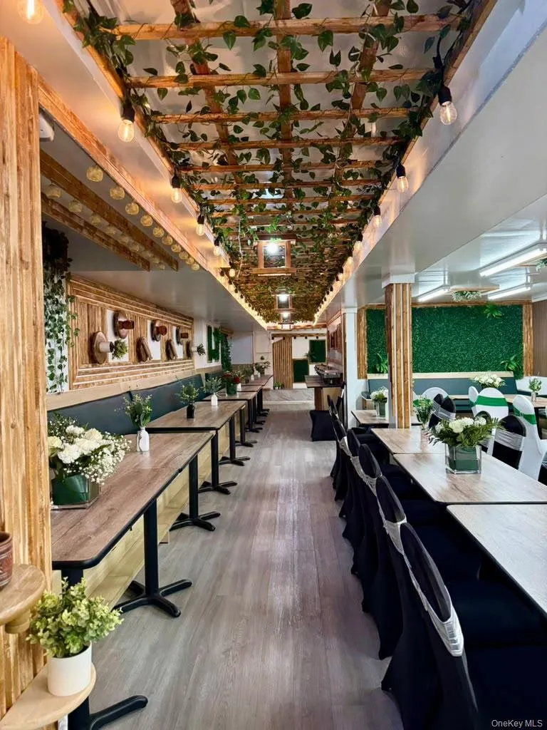 Wood-finish flooring with a decorative ceiling trellis and wood-paneled walls Wood-finish flooring with a decorative ceiling trellis and wood-paneled walls