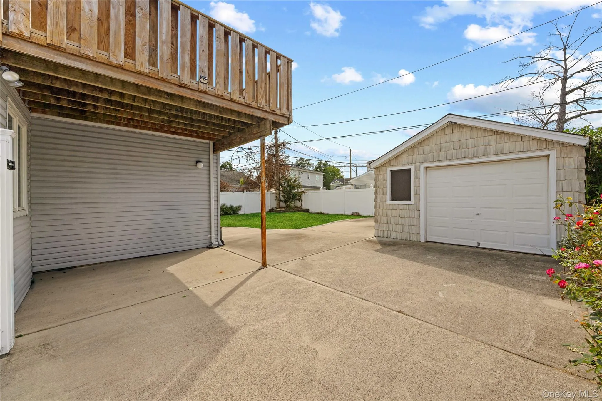 Exterior concrete patio with an overhead wood-plank deck Exterior concrete patio with an overhead wood-plank deck