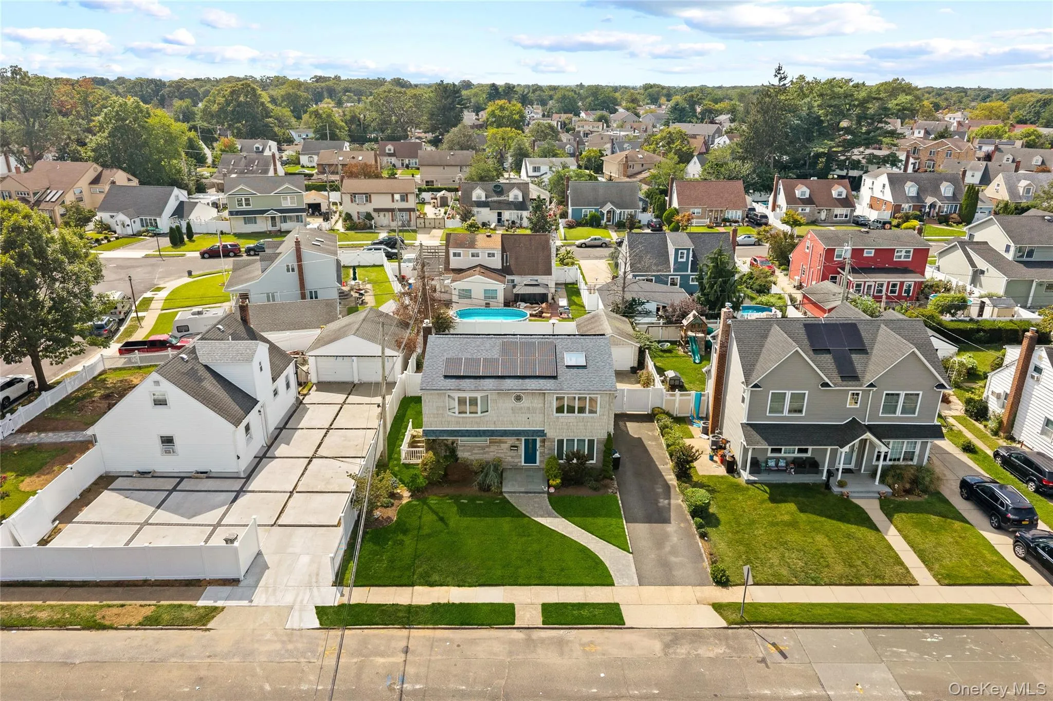 Well-maintained lawn, solar panels, and extensive concrete paving Well-maintained lawn, solar panels, and extensive concrete paving