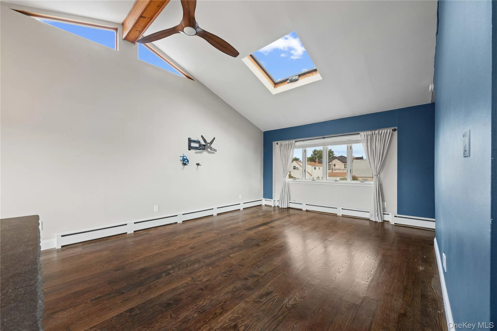 Vaulted ceiling featuring exposed wood beams and a ceiling fan Vaulted ceiling featuring exposed wood beams and a ceiling fan