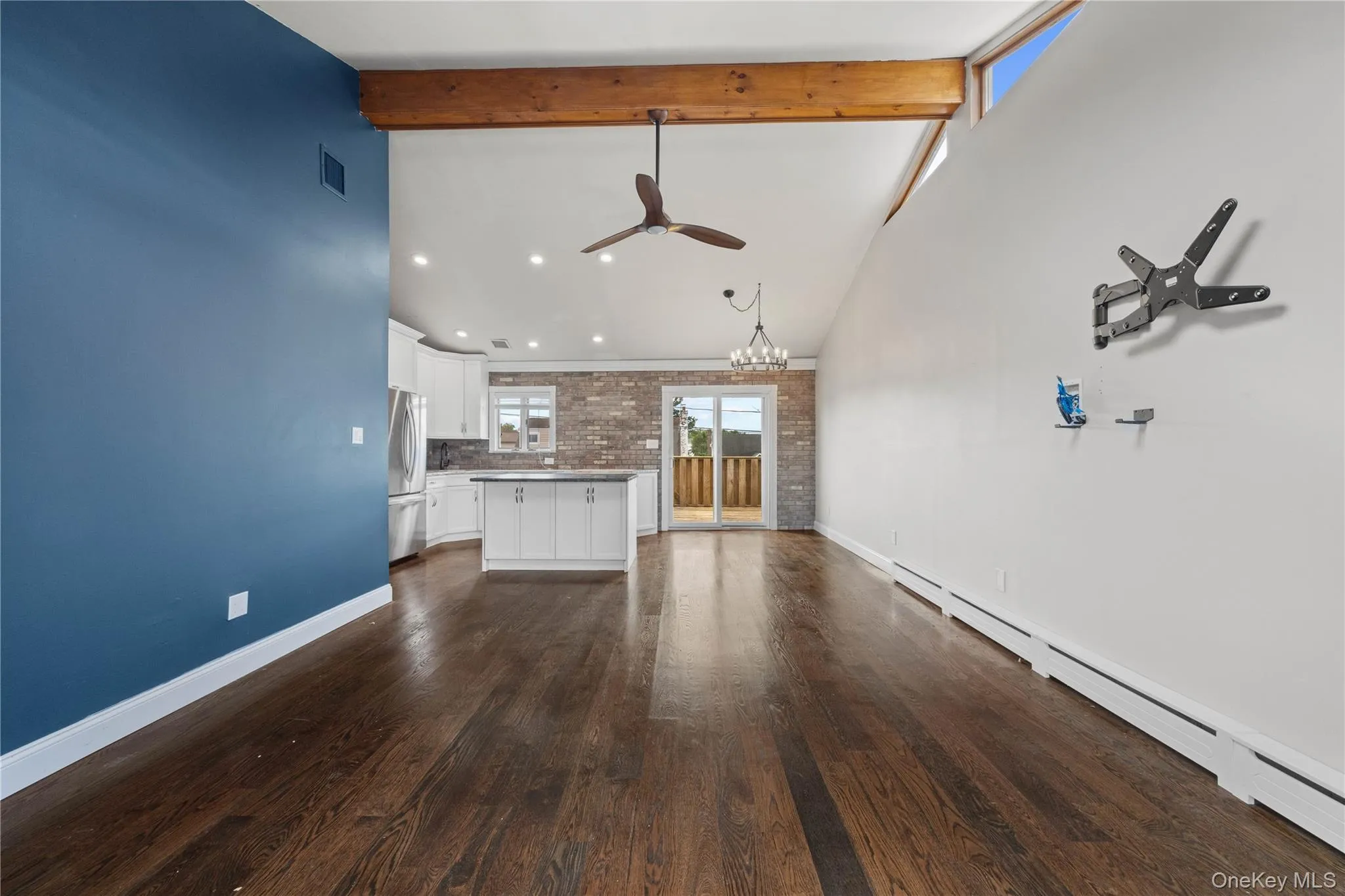 Dark wood-finish flooring with a contrasting blue accent wall Dark wood-finish flooring with a contrasting blue accent wall