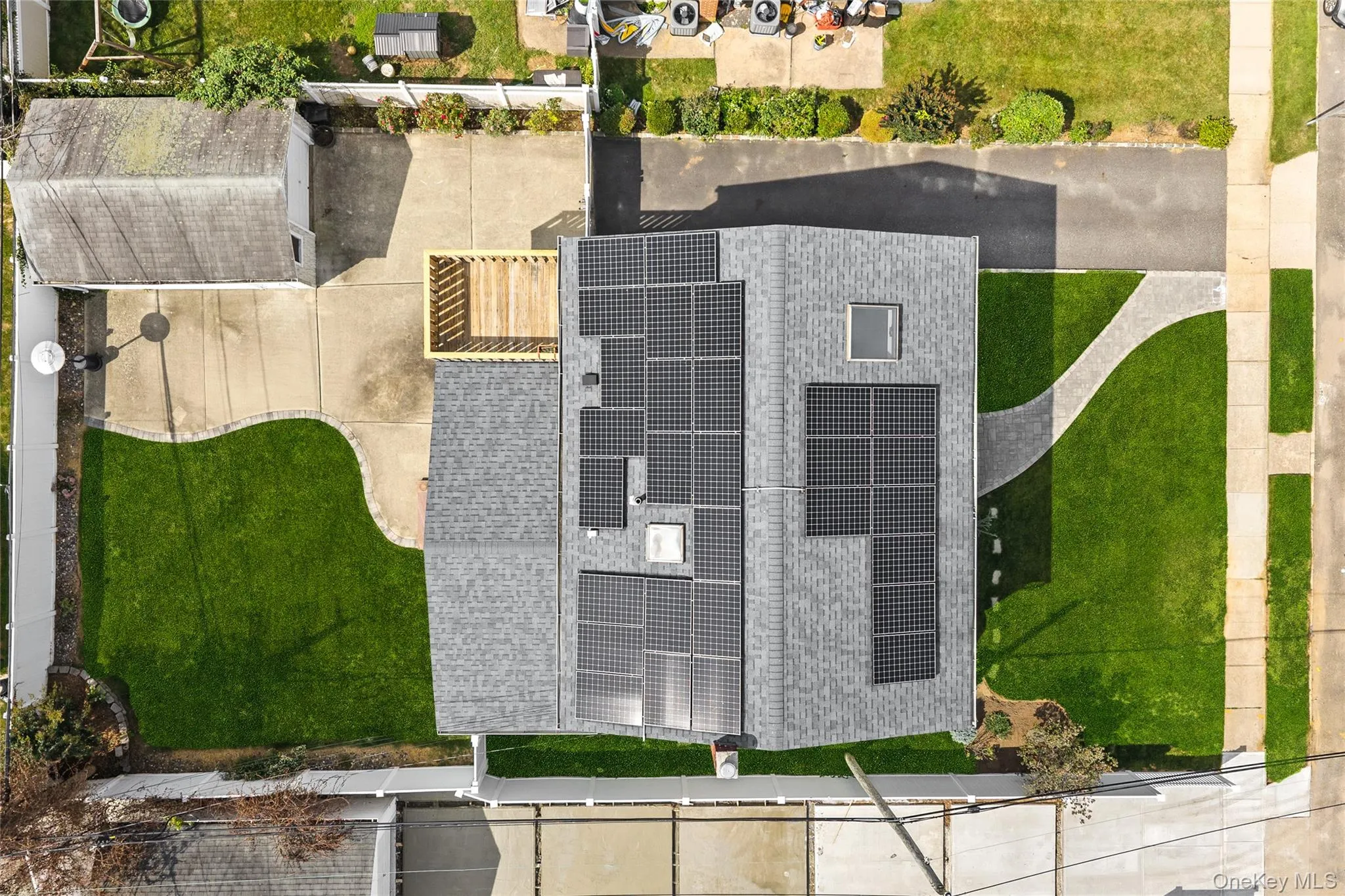 Roofline featuring multiple solar panel arrays and a skylight Roofline featuring multiple solar panel arrays and a skylight