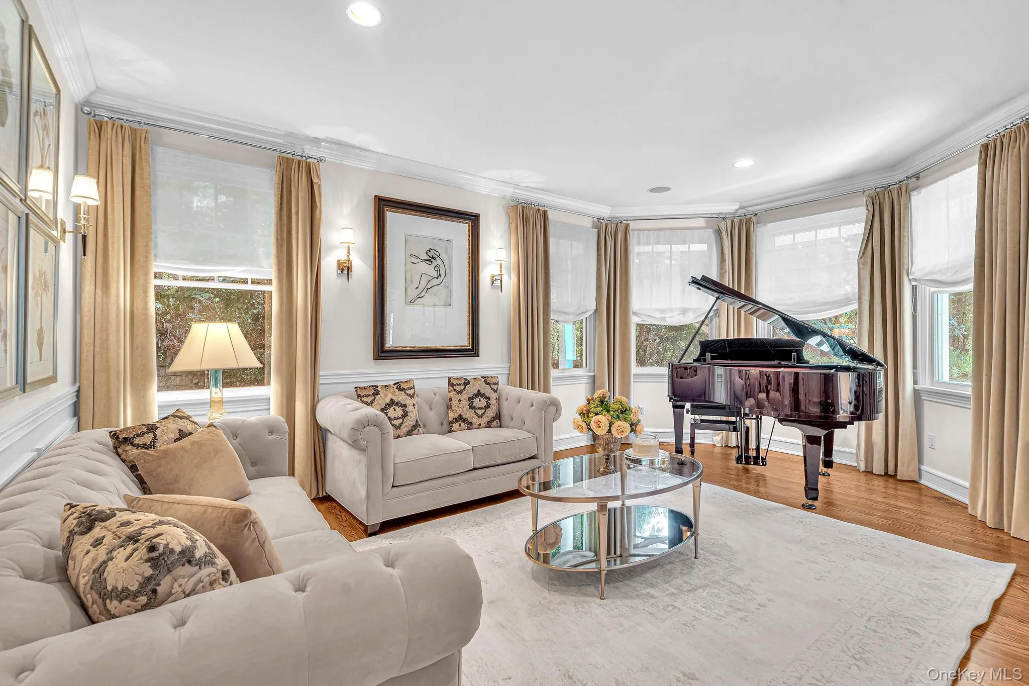 Recessed lighting, crown molding, wood-finish flooring, multiple windows, and wall sconces Recessed lighting, crown molding, wood-finish flooring, multiple windows, and wall sconces