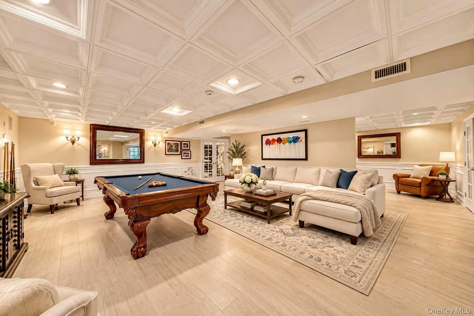 Recessed lighting, light wood-finish flooring, white coffered ceiling, wainscoting, and double French doors Recessed lighting, light wood-finish flooring, white coffered ceiling, wainscoting, and double French doors