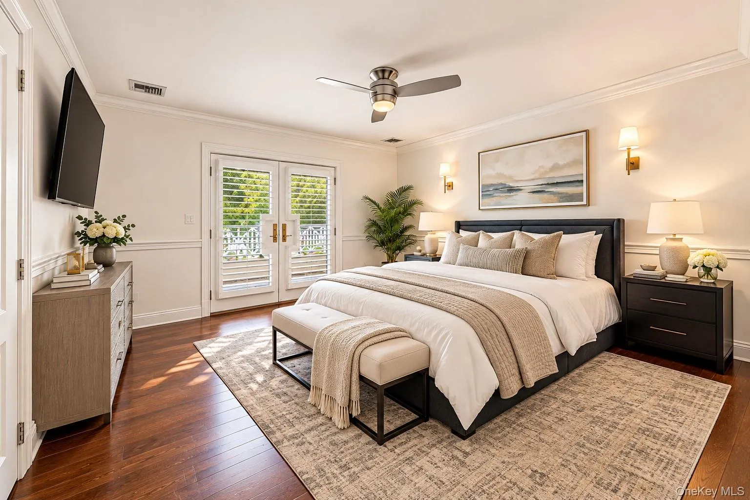Hardwood flooring, crown molding, double French doors with interior shutters, wall-mounted sconces, and a ceiling fan with integrated lighting Hardwood flooring, crown molding, double French doors with interior shutters, wall-mounted sconces, and a ceiling fan with integrated lighting
