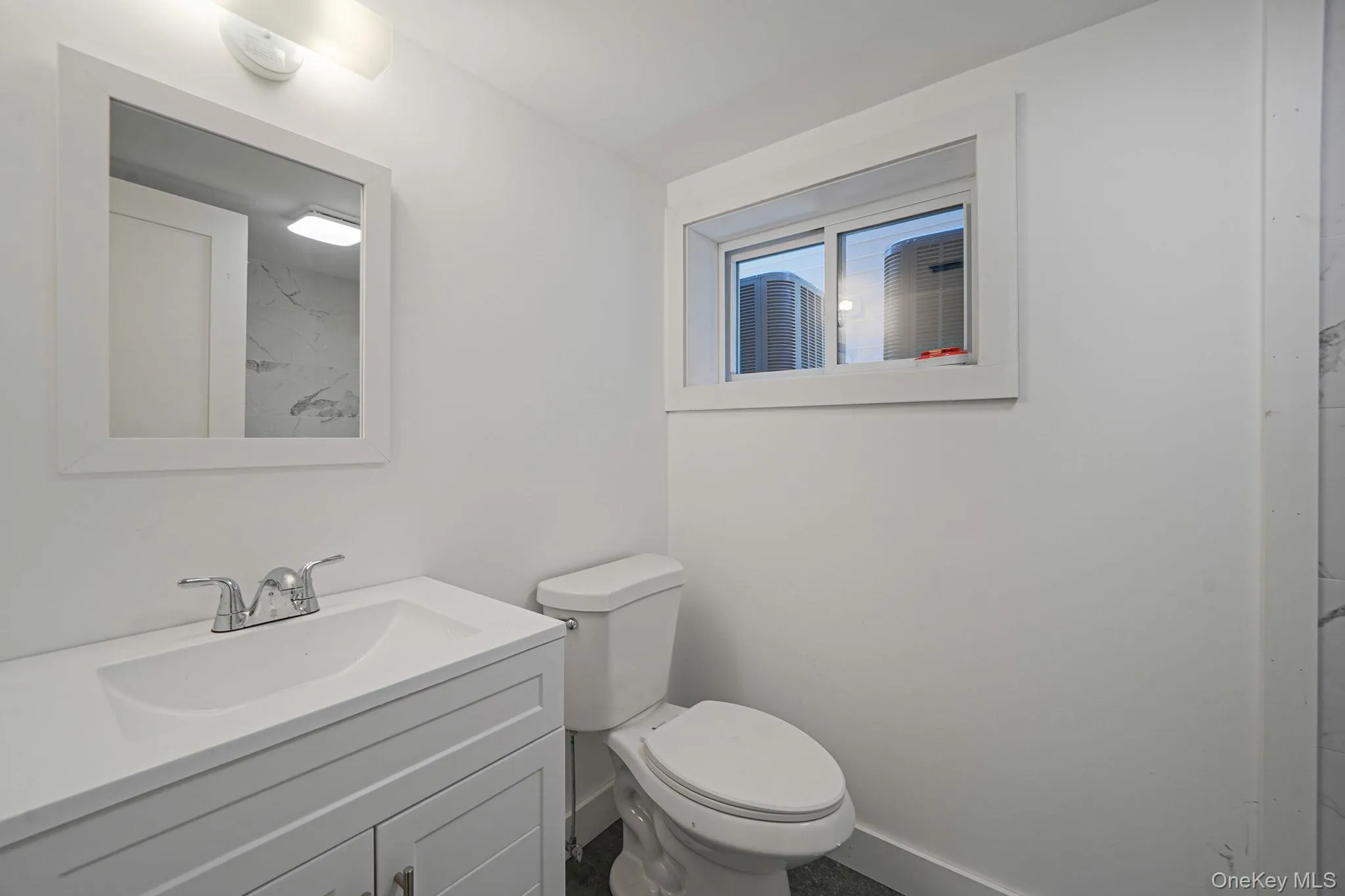 Bathroom with vanity, toilet, and baseboards Bathroom with vanity, toilet, and baseboards
