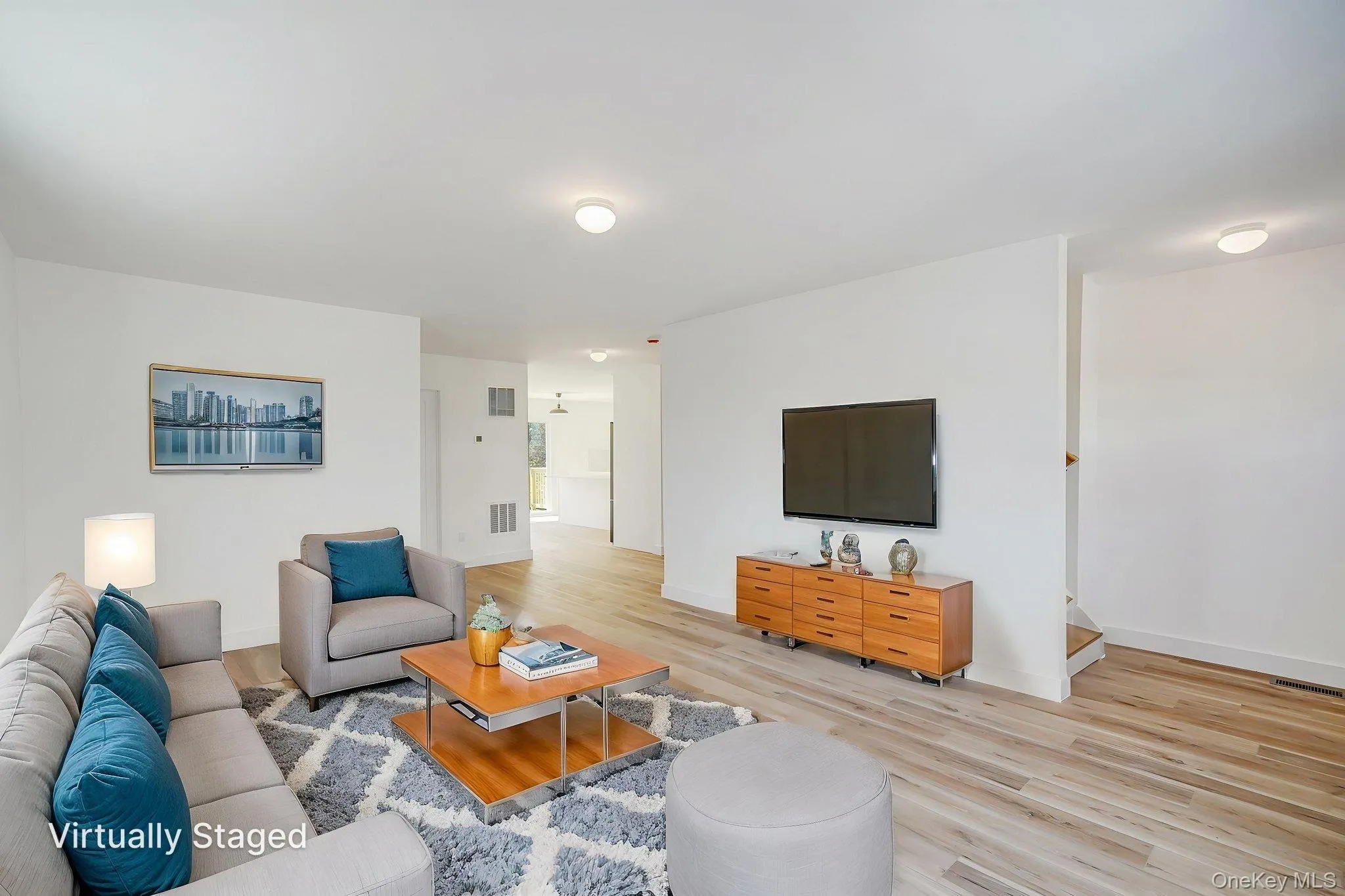 Living room with light wood-style floors and baseboards Living room with light wood-style floors and baseboards