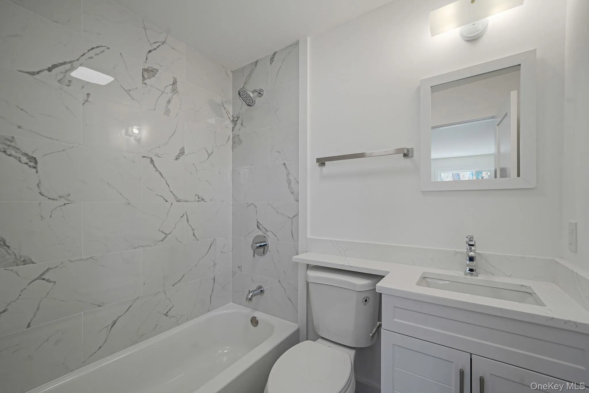 Full bath featuring vanity, toilet, and shower / bath combination Full bath featuring vanity, toilet, and shower / bath combination