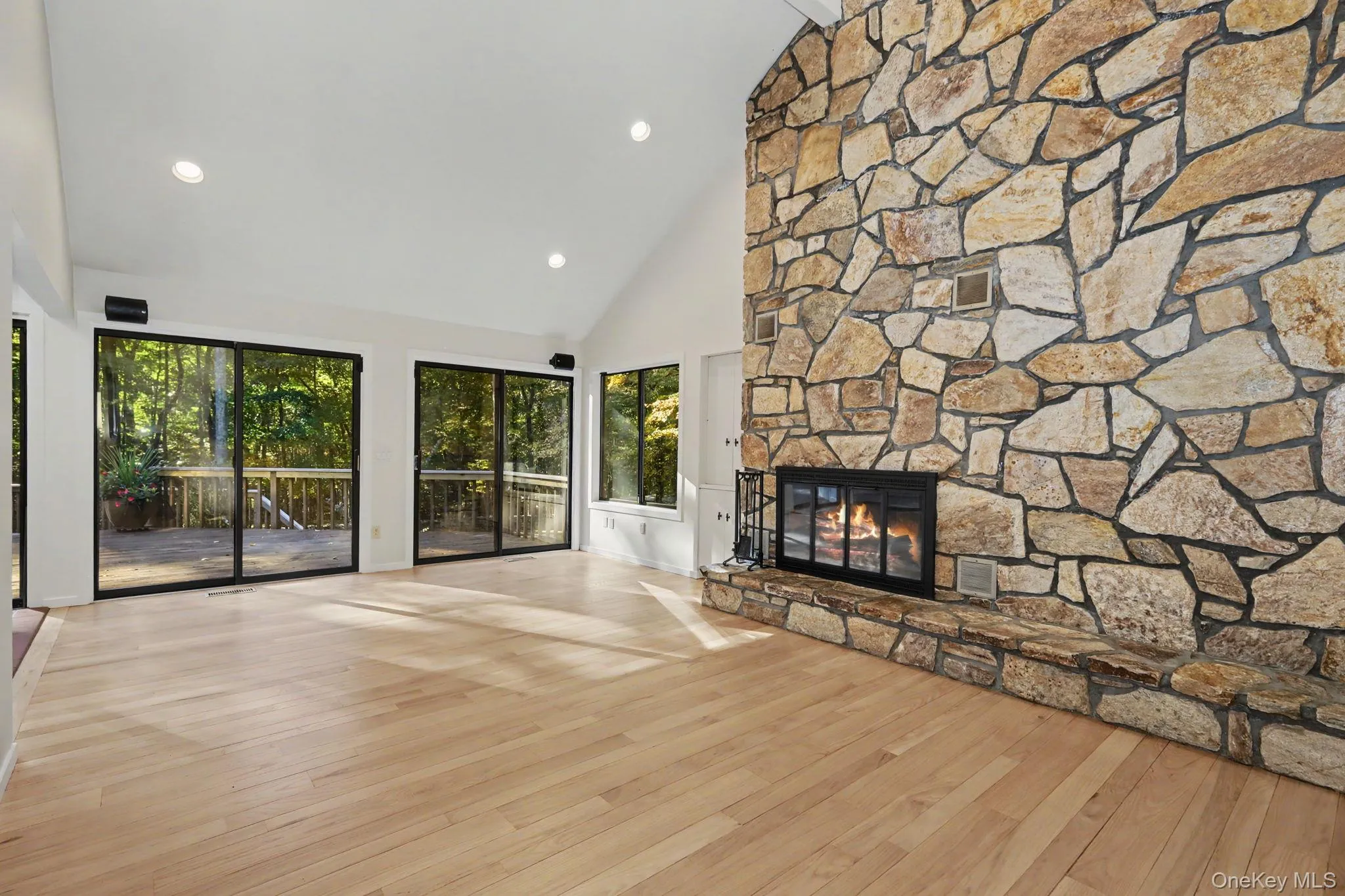 Sliding doors open to the deck overlooking the private wooded grounds. Sliding doors open to the deck overlooking the private wooded grounds.
