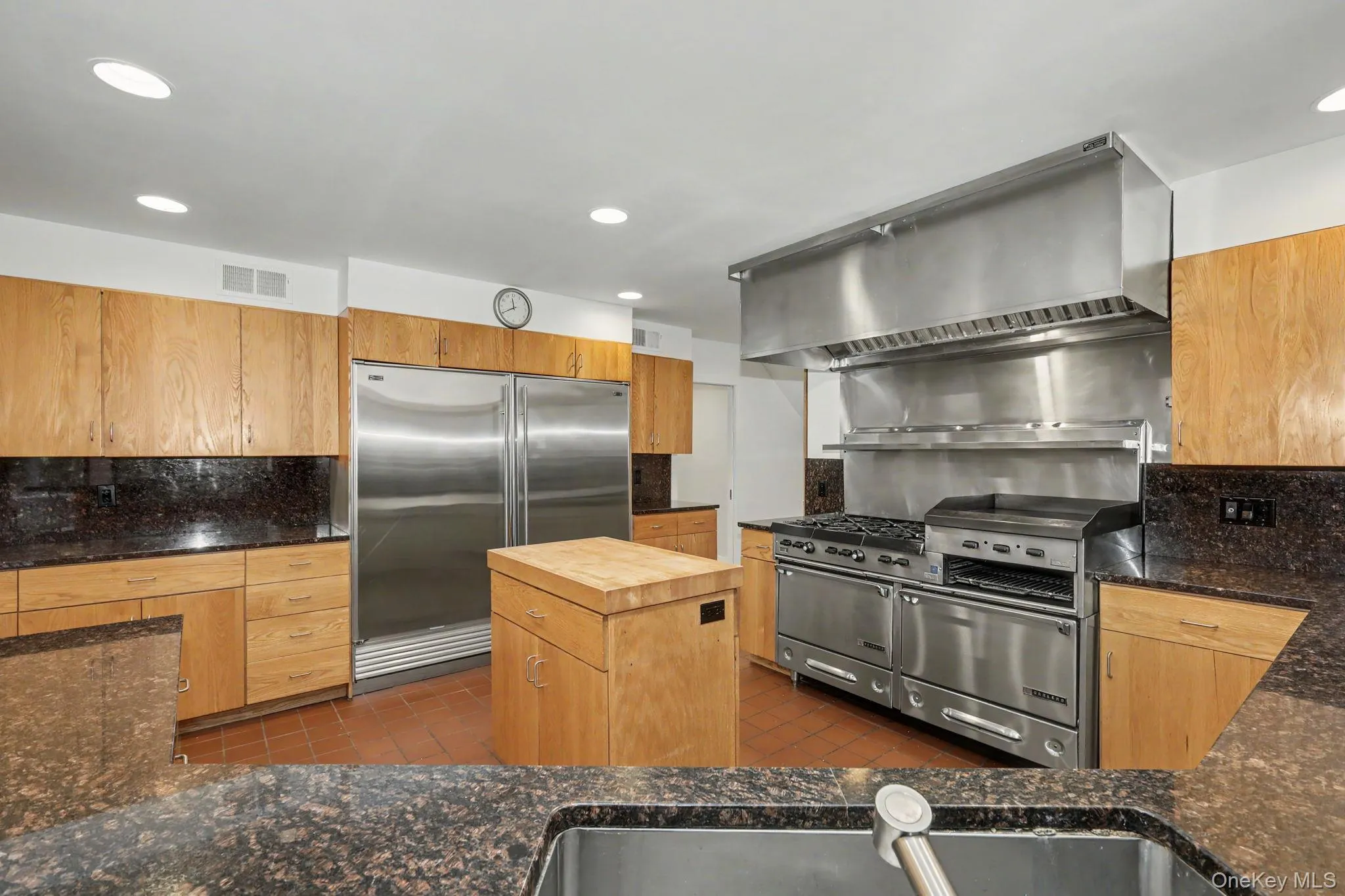 Professional Garland range with griddle, salamander, and double ovens, complemented by Sub Zero refrigeration. Professional Garland range with griddle, salamander, and double ovens, complemented by Sub Zero refrigeration.