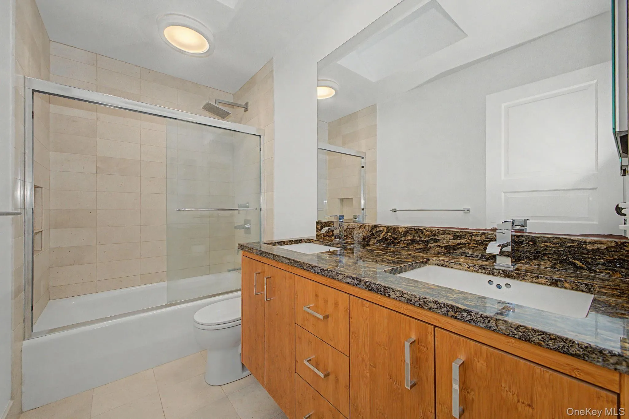 Skylit bathroom shared by two bedrooms. Skylit bathroom shared by two bedrooms.