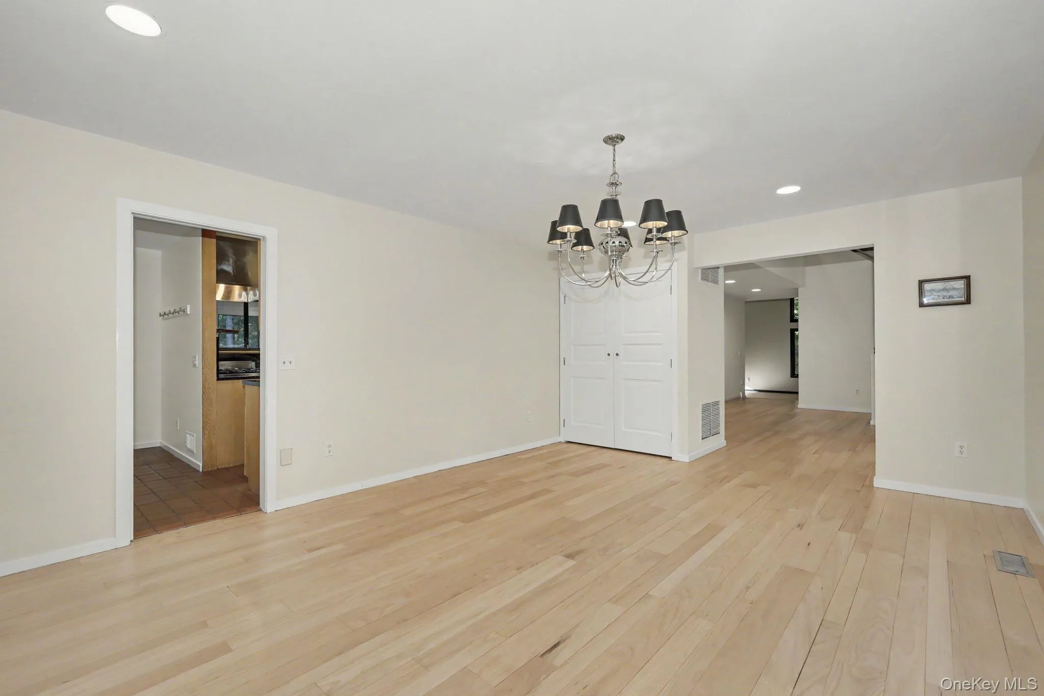 Light-filled formal dining room with a large picture window and direct access to the kitchen, ideal for entertaining. Light-filled formal dining room with a large picture window and direct access to the kitchen, ideal for entertaining.