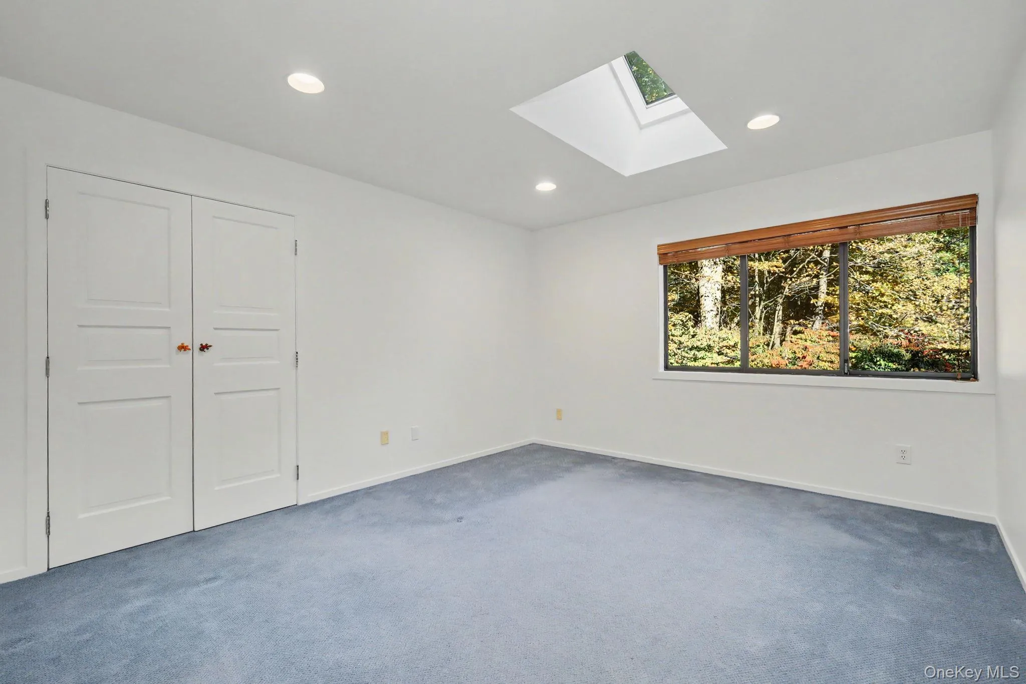 Bedroom 2 with skylight and large window overlooking the backyard. Bedroom 2 with skylight and large window overlooking the backyard.