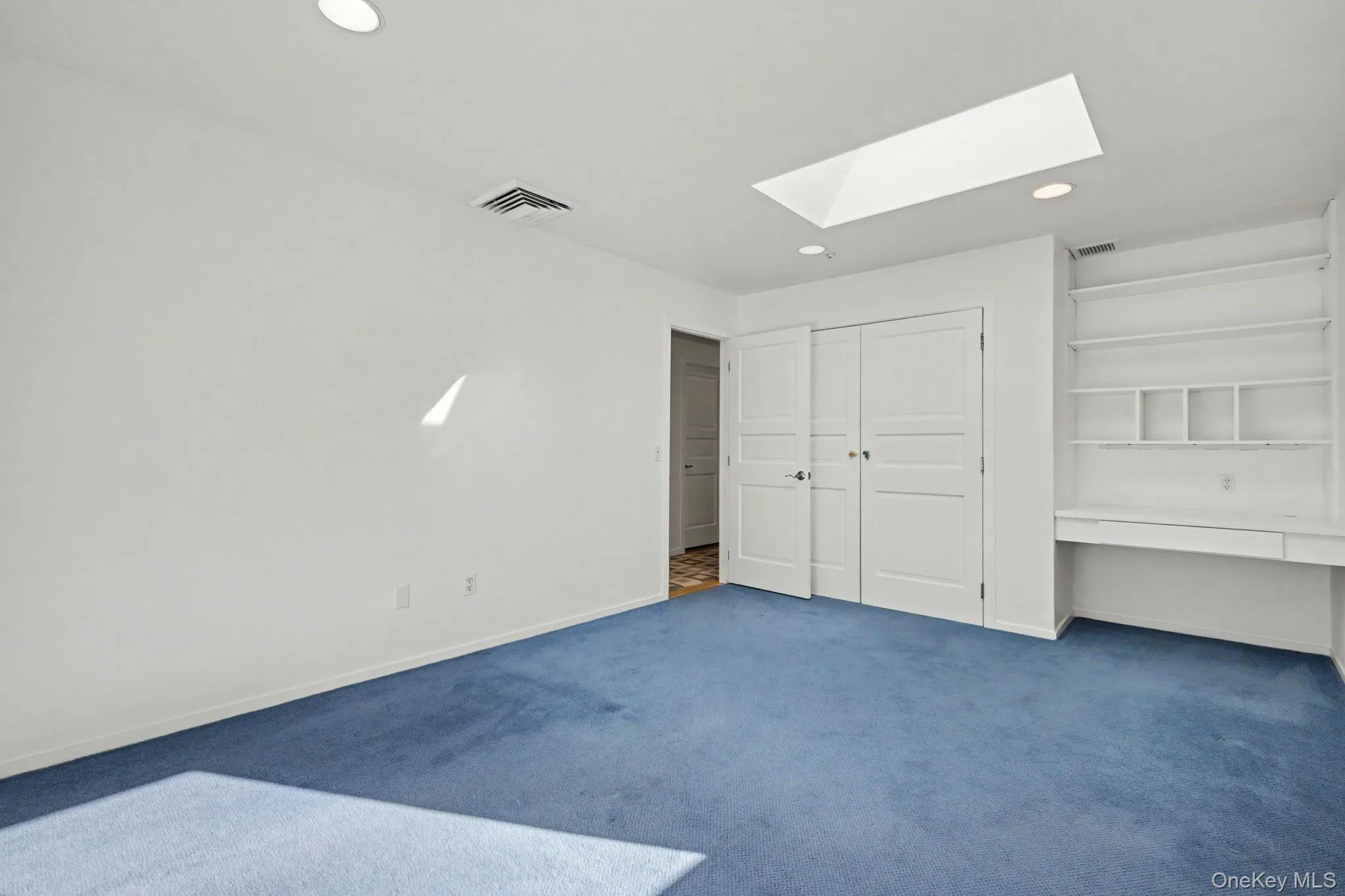 Bedroom 3 with skylight and built-in desk with shelving. Bedroom 3 with skylight and built-in desk with shelving.