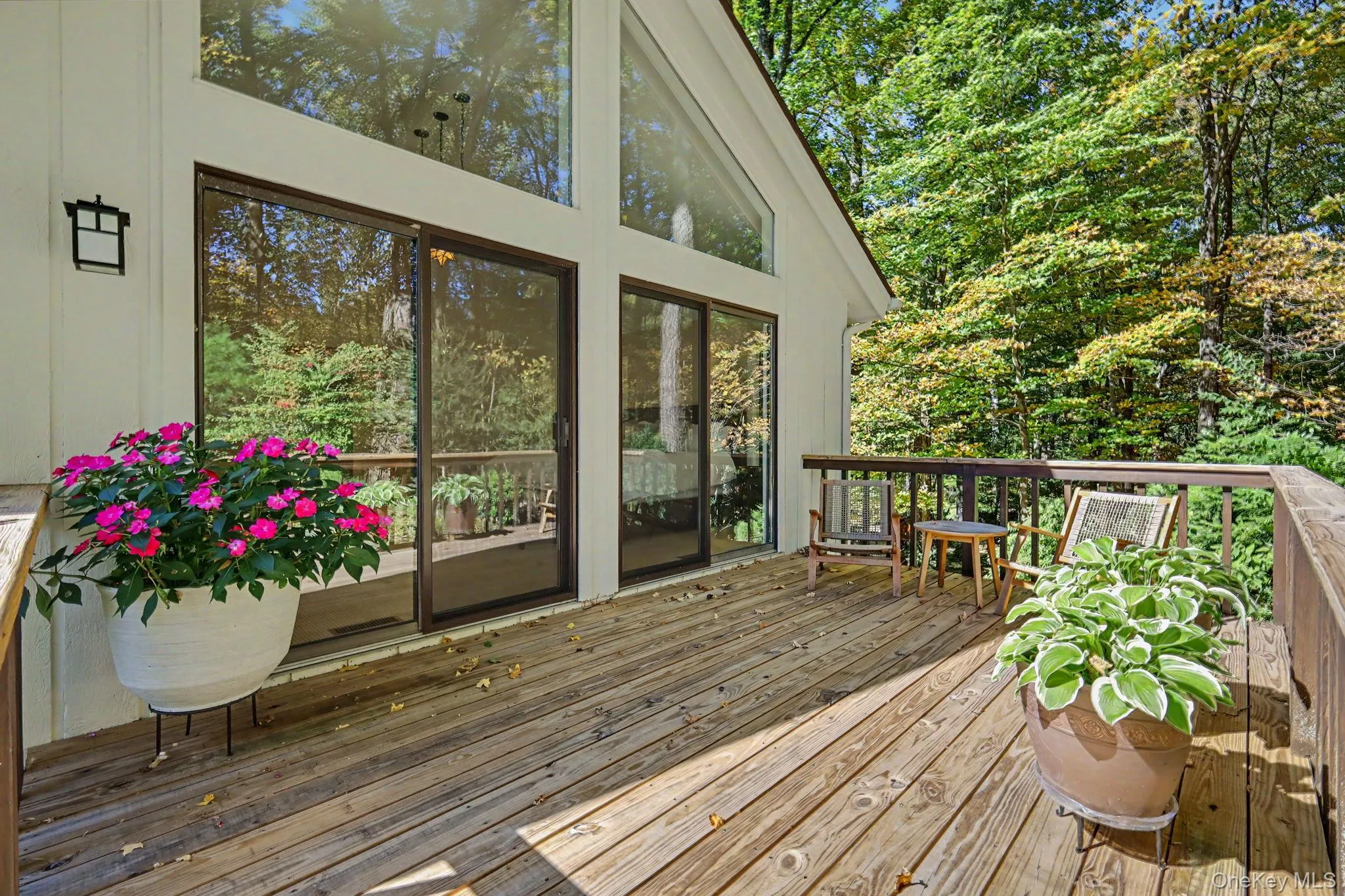A private oasis off the primary bedroom, perfect for morning coffee amid peaceful wooded surroundings. A private oasis off the primary bedroom, perfect for morning coffee amid peaceful wooded surroundings.