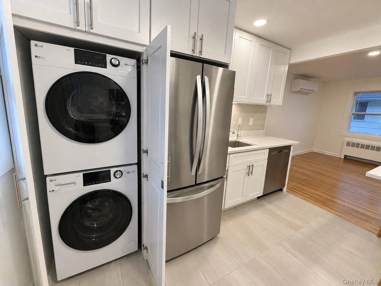 NEW stacked washer/dryer unit in cabinetry located in kitchen NEW stacked washer/dryer unit in cabinetry located in kitchen
