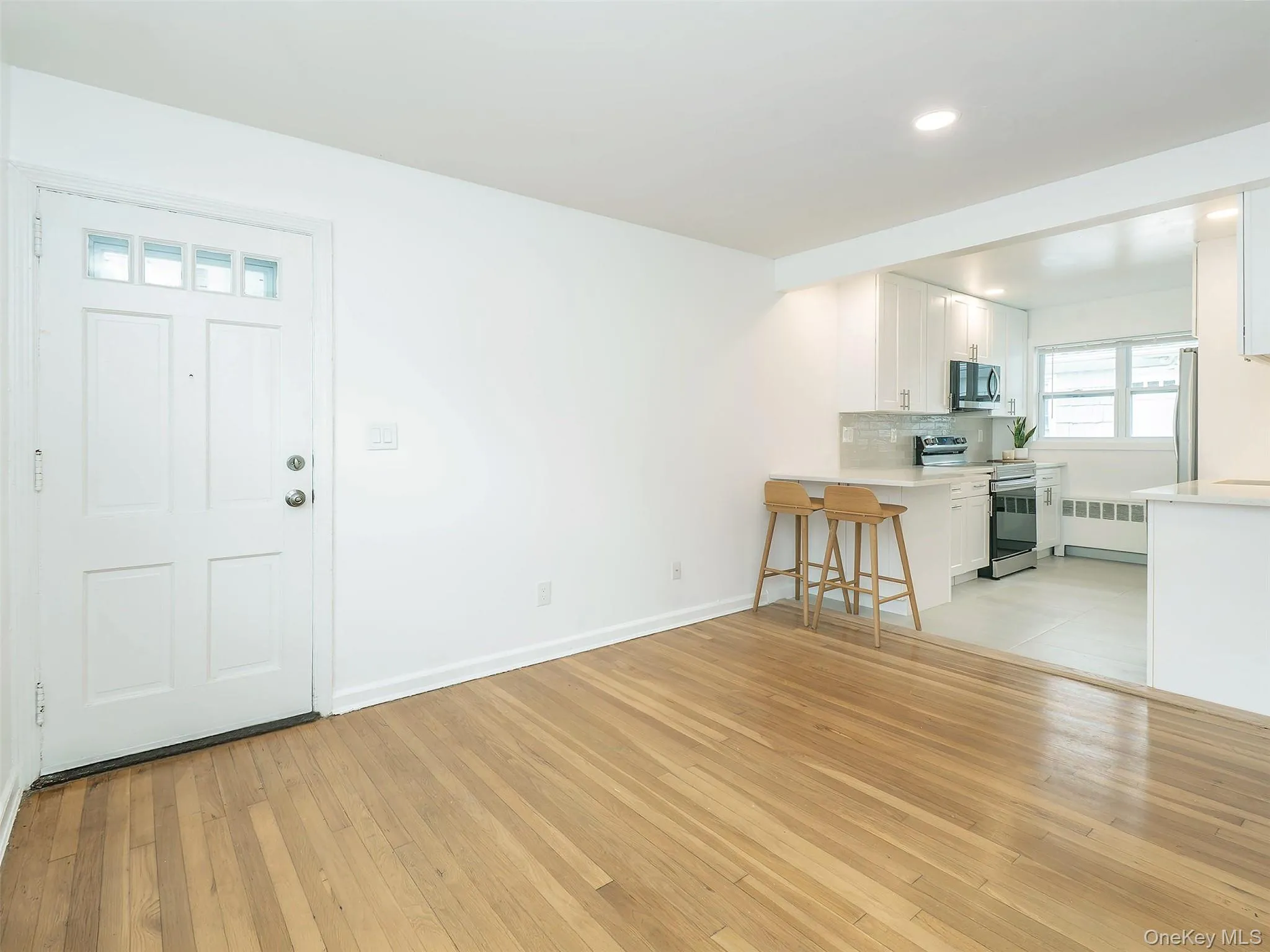 Living room is open to the kitchen. Beautiful hardwood floors. Living room is open to the kitchen. Beautiful hardwood floors.
