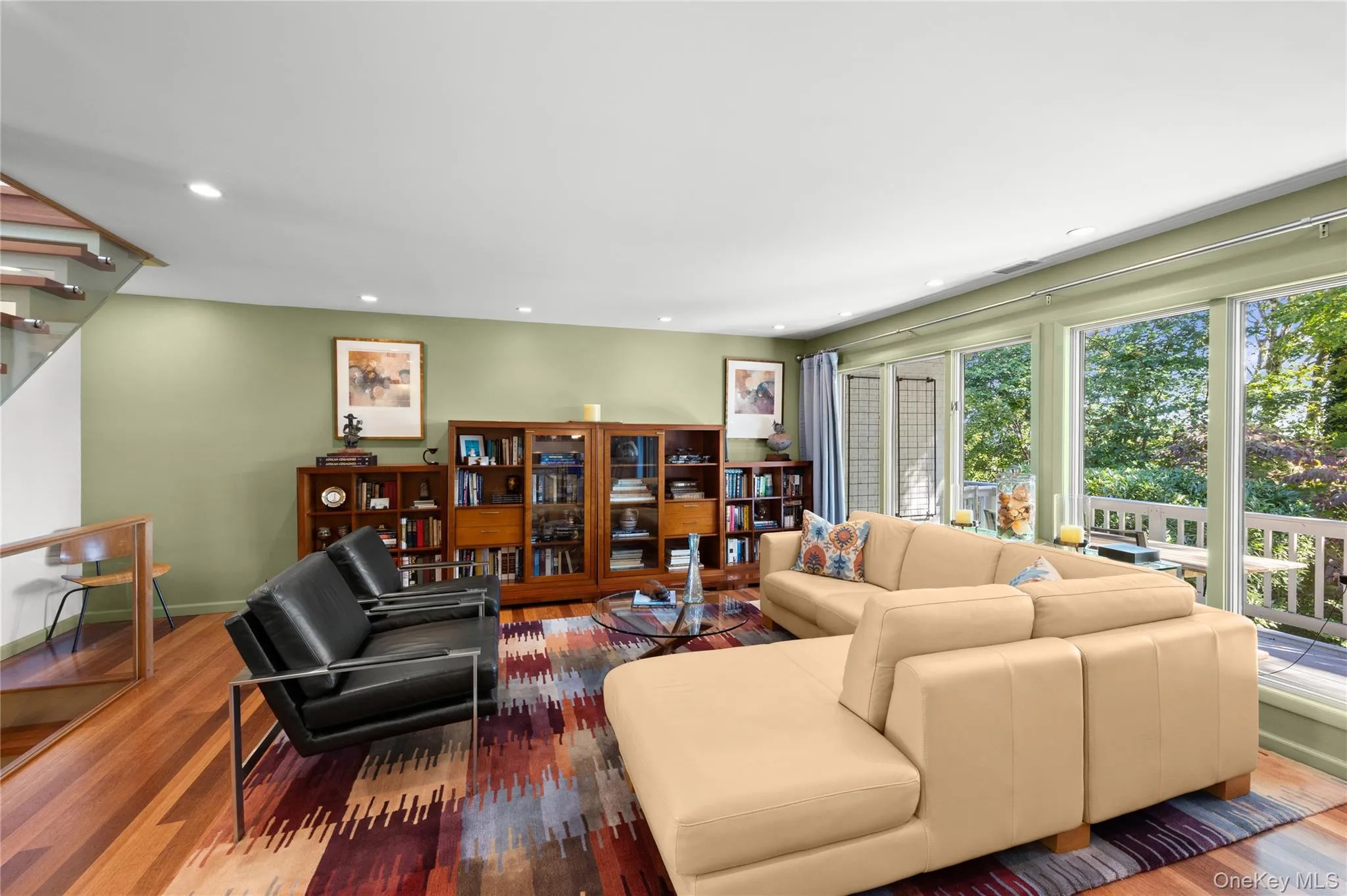 Living room with floor to ceiling windows recessed lighting and Kempas HW floors throughout Living room with floor to ceiling windows recessed lighting and Kempas HW floors throughout