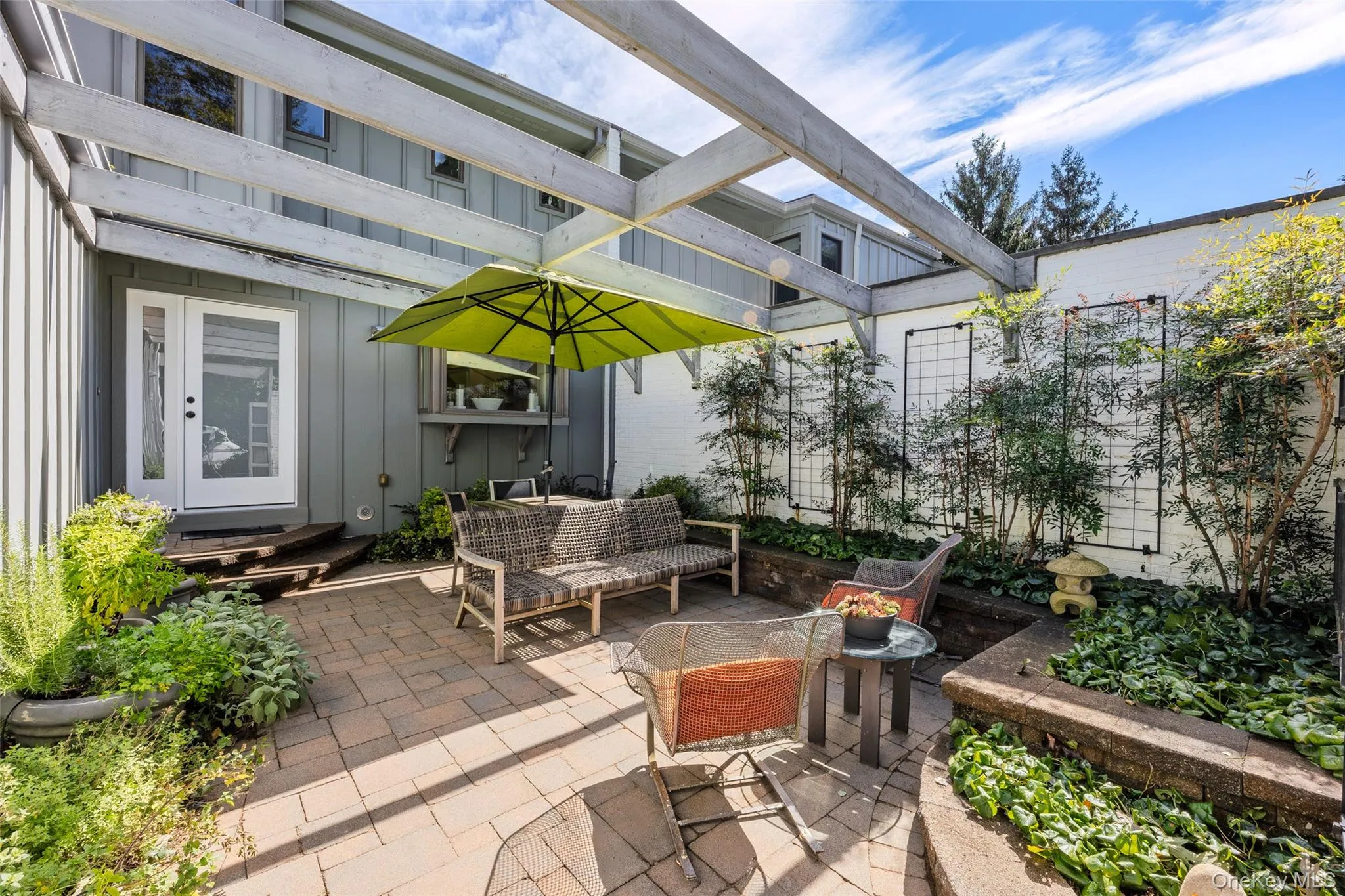 Private front courtyard with brick patio and lovely gardens Private front courtyard with brick patio and lovely gardens