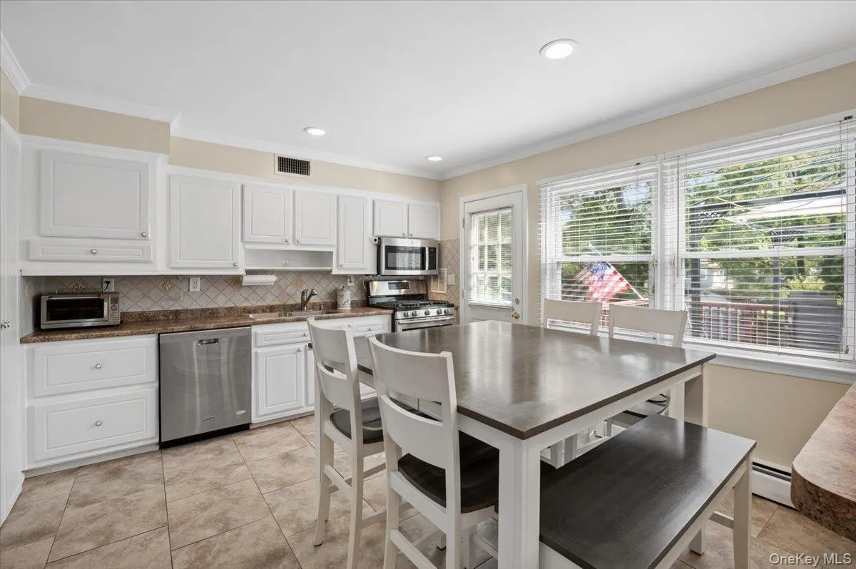 Eat-in kitchen with stainless steel appliances, breakfast bar and access to your deck. Eat-in kitchen with stainless steel appliances, breakfast bar and access to your deck.
