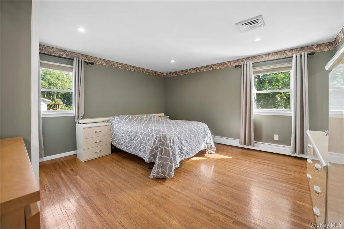 Spacious primary bedroom with ample closets, hardwood floors, recessed lighting and en-suite bath. Spacious primary bedroom with ample closets, hardwood floors, recessed lighting and en-suite bath.