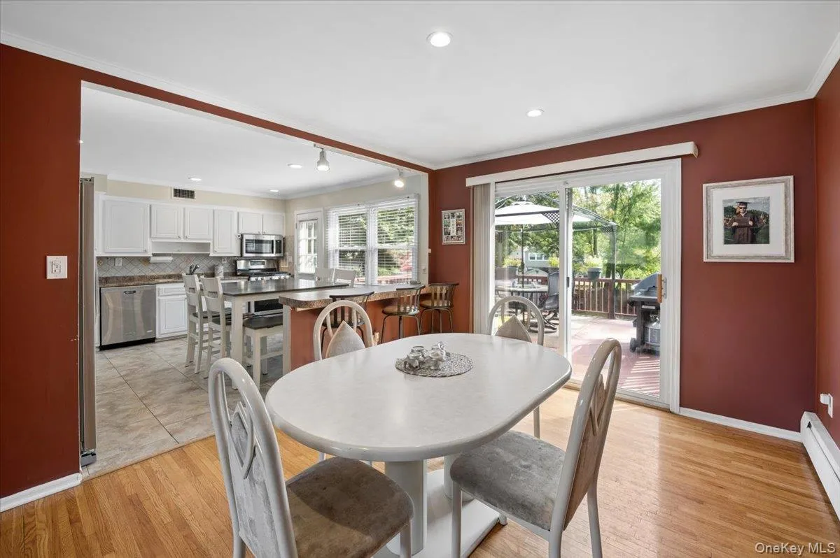 Formal dining room opens to your eat-in kitchen and sliders lead to the large deck. Formal dining room opens to your eat-in kitchen and sliders lead to the large deck.