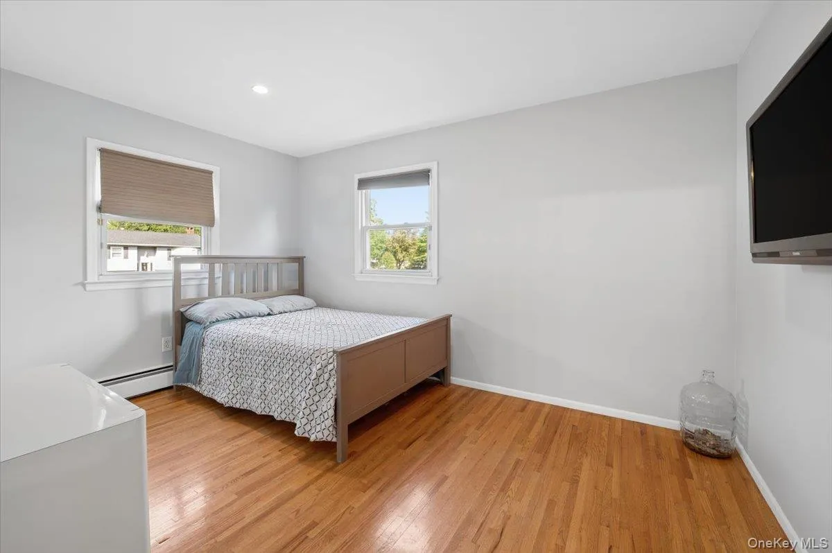Second bedroom with hardwood floors and recessed lighting. Second bedroom with hardwood floors and recessed lighting.