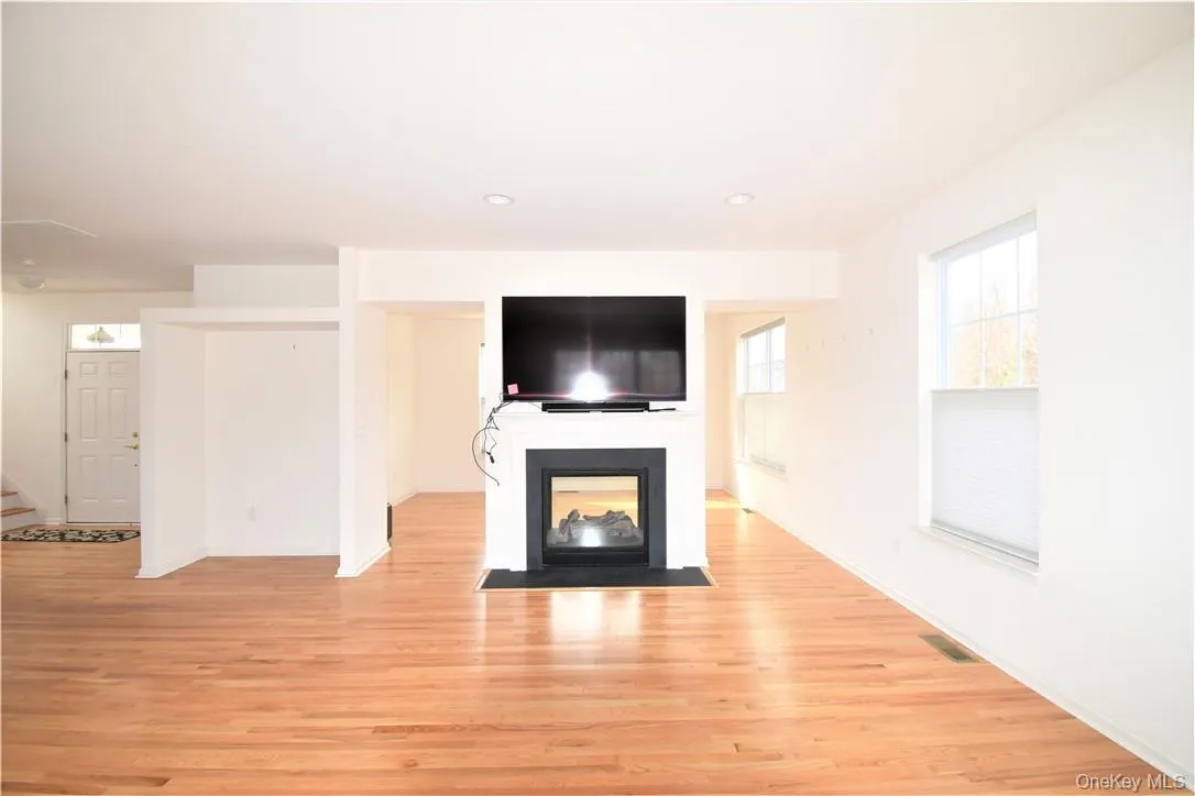 Spacious open living room with double sided fireplace Spacious open living room with double sided fireplace