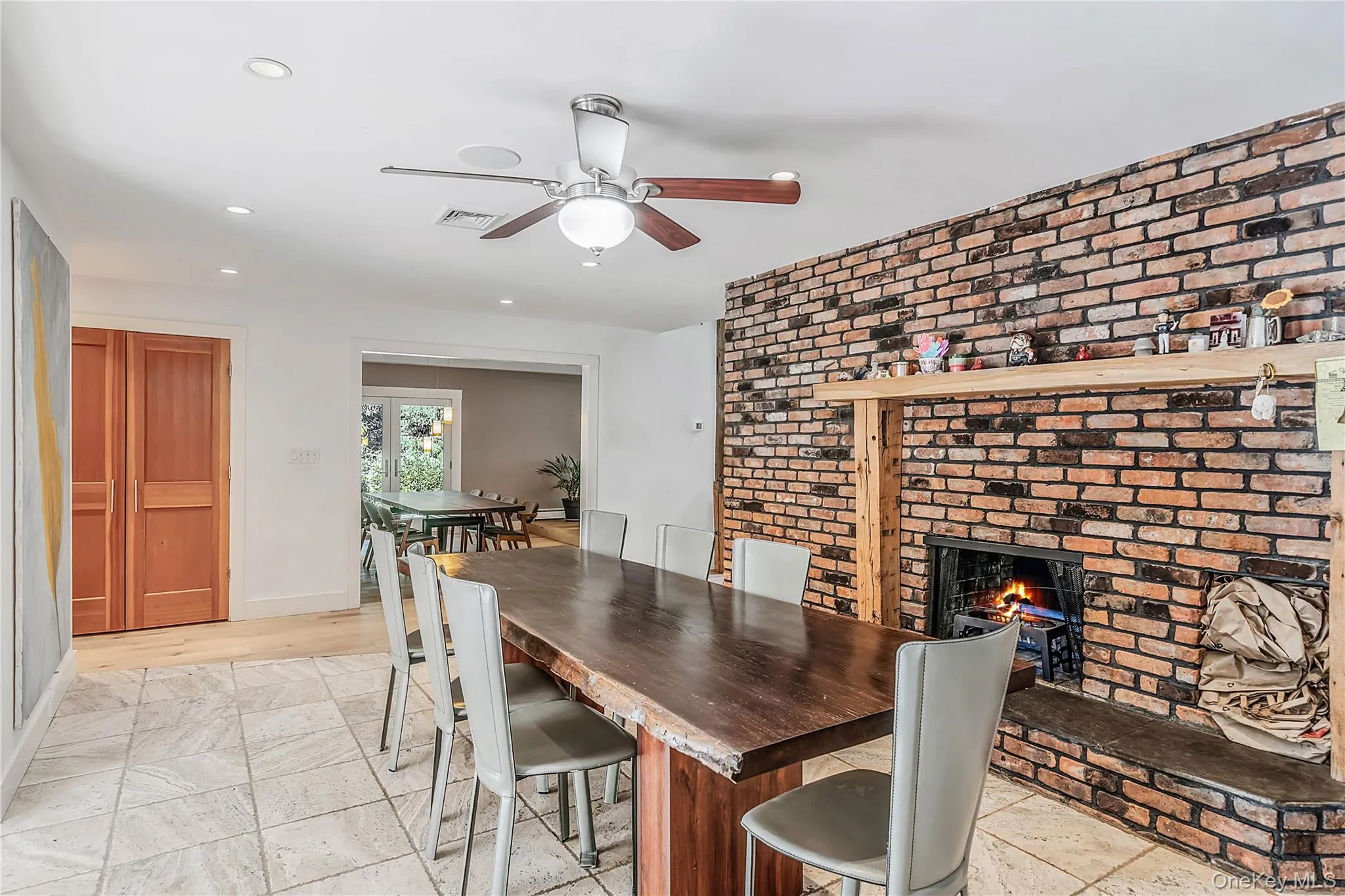 Brick fireplace, ceiling fan, tiled floor Brick fireplace, ceiling fan, tiled floor