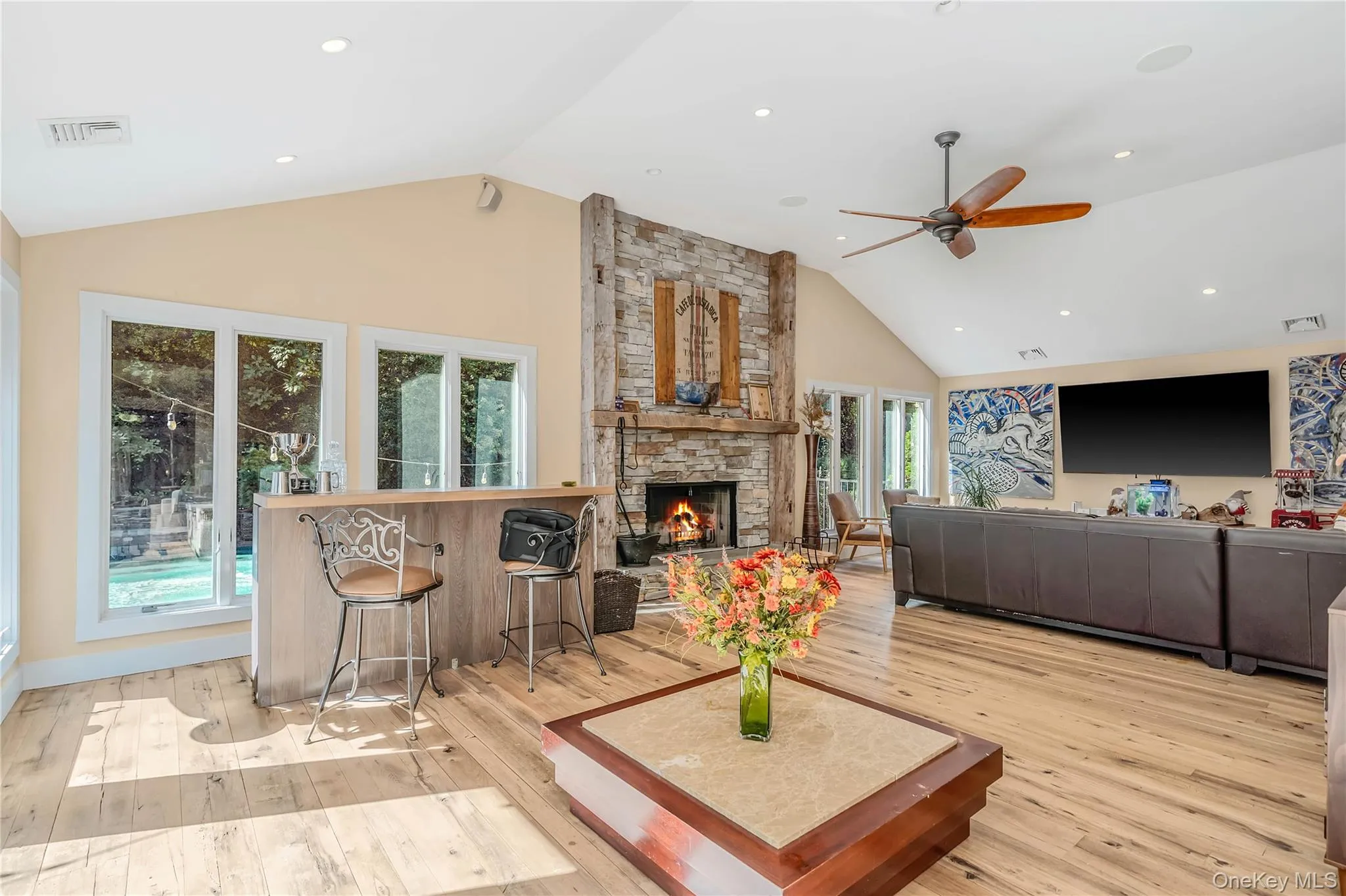 Stone fireplace, wood floors, recessed lighting Stone fireplace, wood floors, recessed lighting