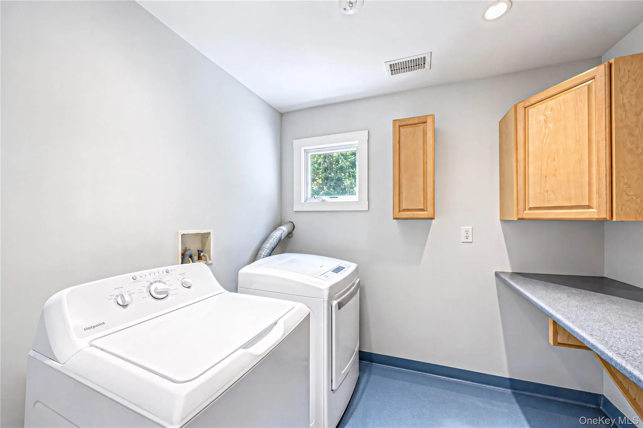 Seconf floor laundry with folding area and cabinetry Seconf floor laundry with folding area and cabinetry
