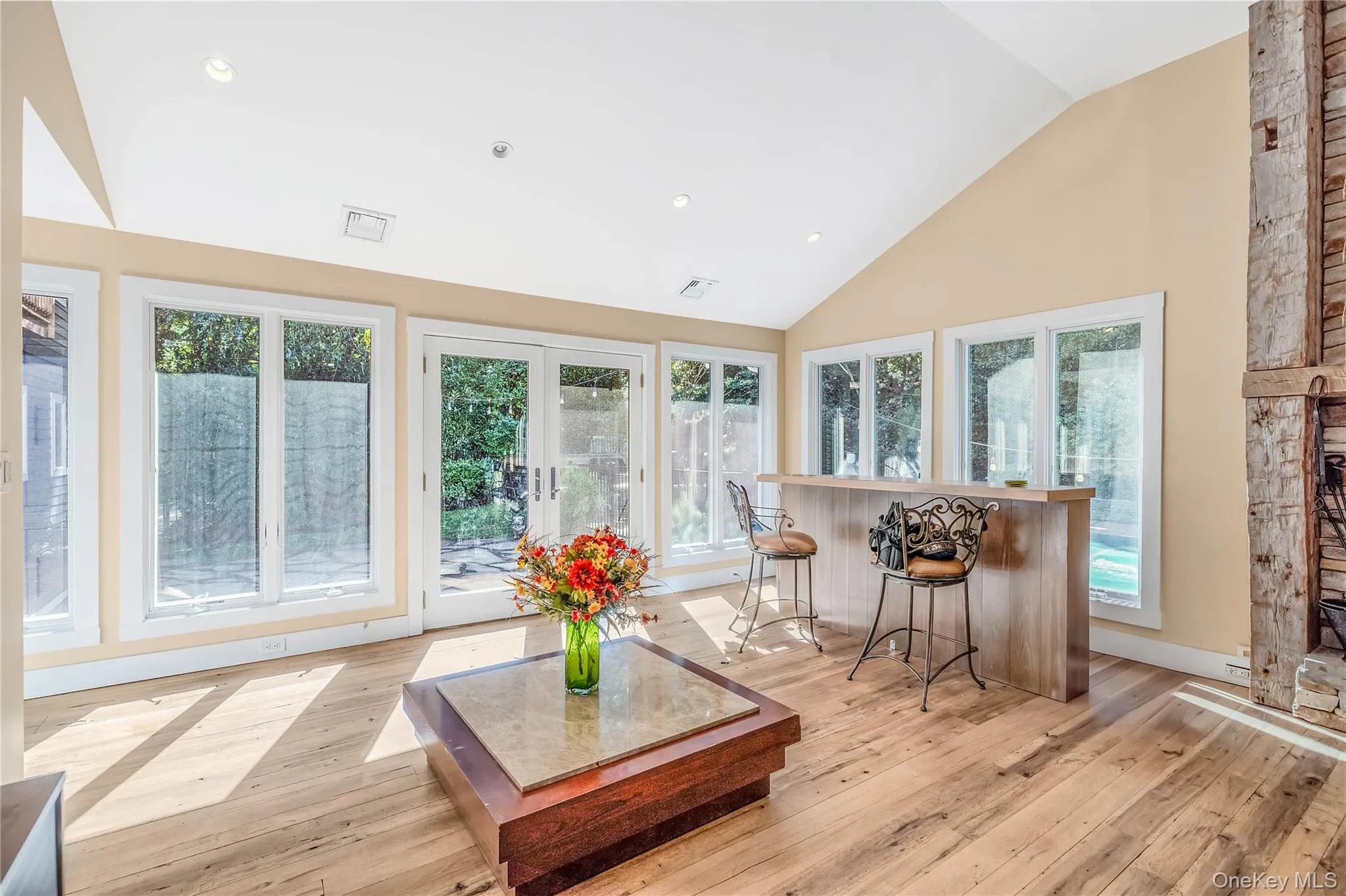 Window wrapped walls, french door to patio and yard Window wrapped walls, french door to patio and yard