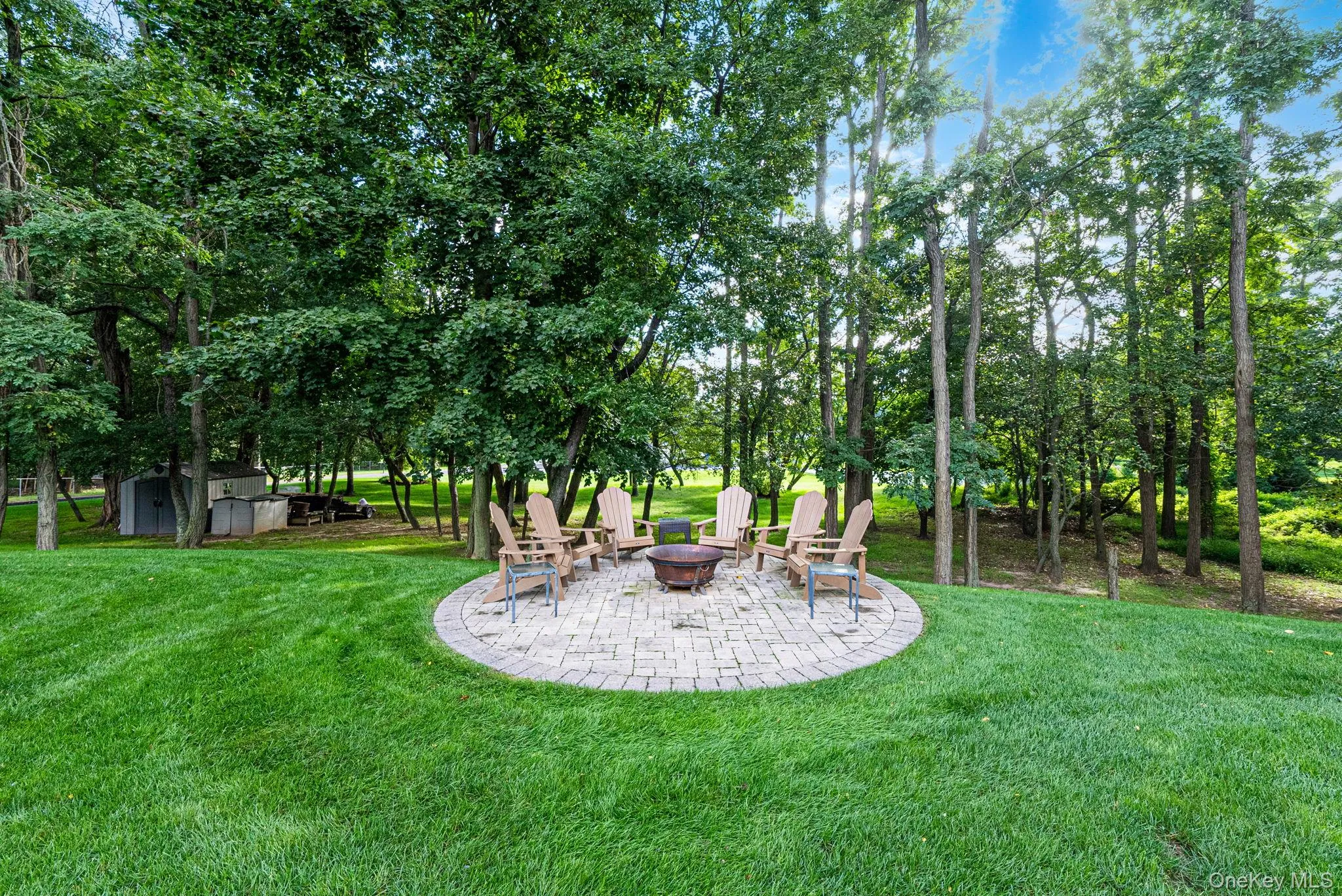 Lush grounds with mature landscape, stone patio with patio Lush grounds with mature landscape, stone patio with patio