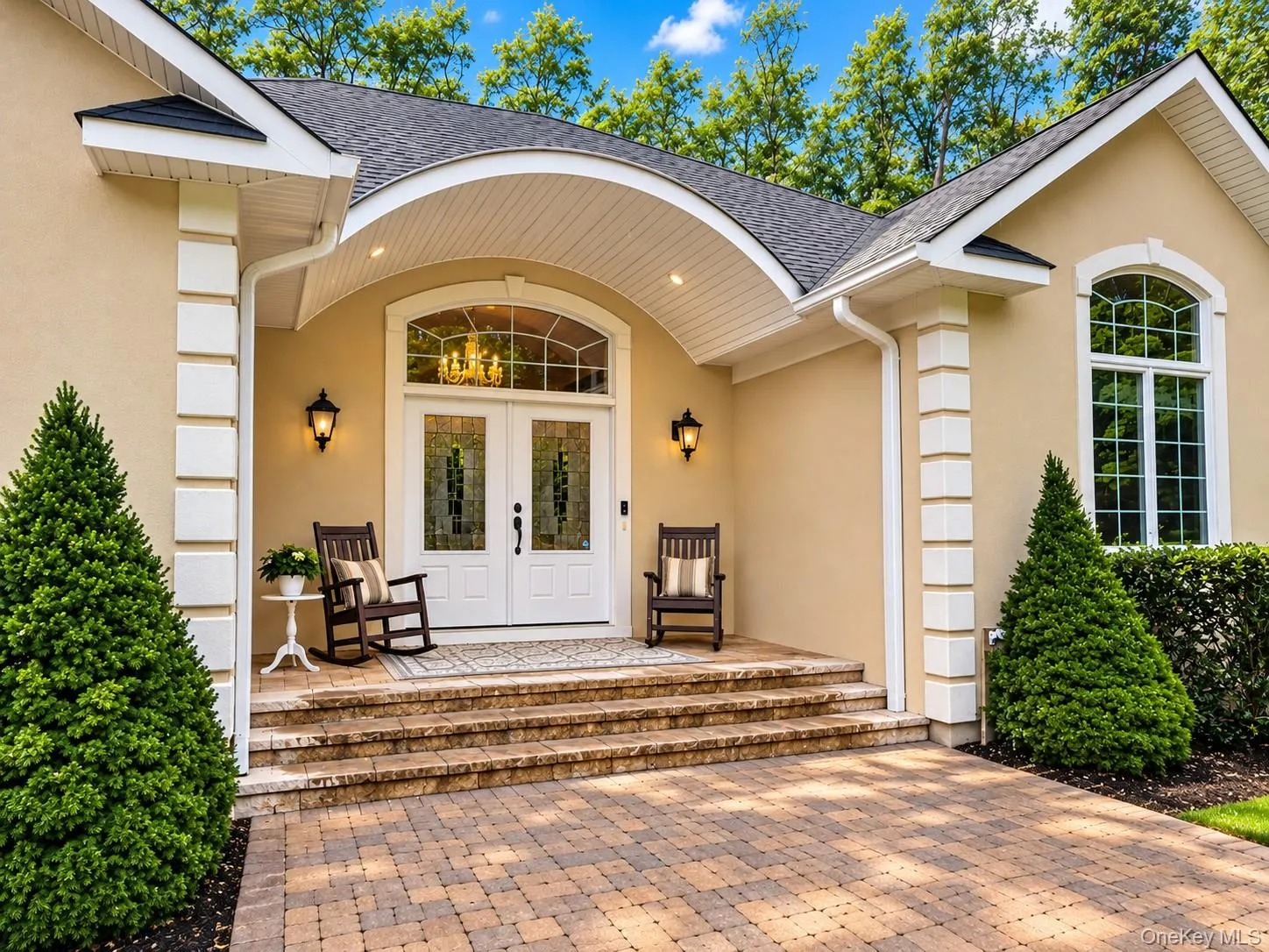 Elgant covered entry with stoen walkways leading from driveway Elgant covered entry with stoen walkways leading from driveway