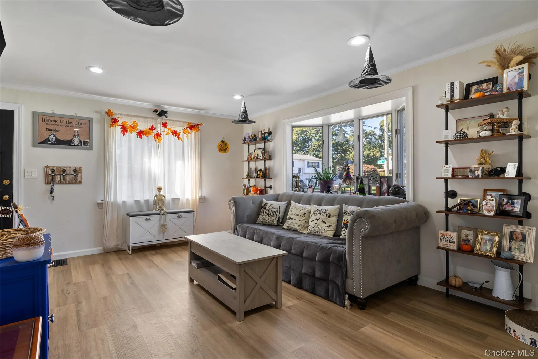 Bay window with multiple panes, wood-finish flooring, recessed lighting, and built-in shelving Bay window with multiple panes, wood-finish flooring, recessed lighting, and built-in shelving