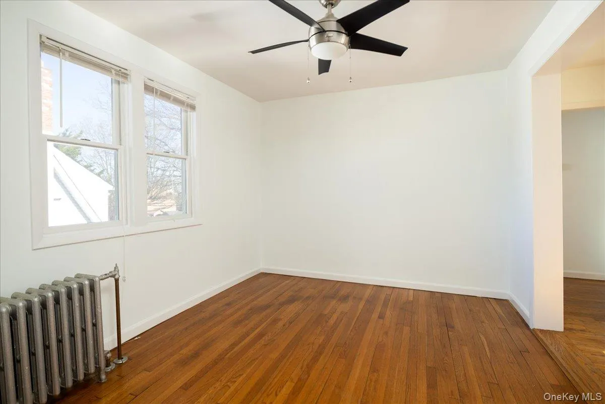 Second Floor Dining Room featuring wood-finish flooring, dual-pane windows, and a ceiling fan with integrated lighting Second Floor Dining Room featuring wood-finish flooring, dual-pane windows, and a ceiling fan with integrated lighting