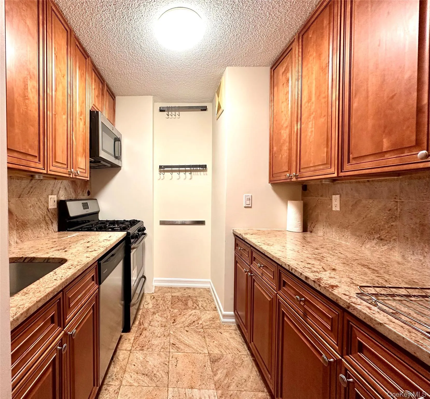 Kitchen with Granite counters and floors. Full stove, microwabe and refrigerator. Kitchen with Granite counters and floors. Full stove, microwabe and refrigerator.