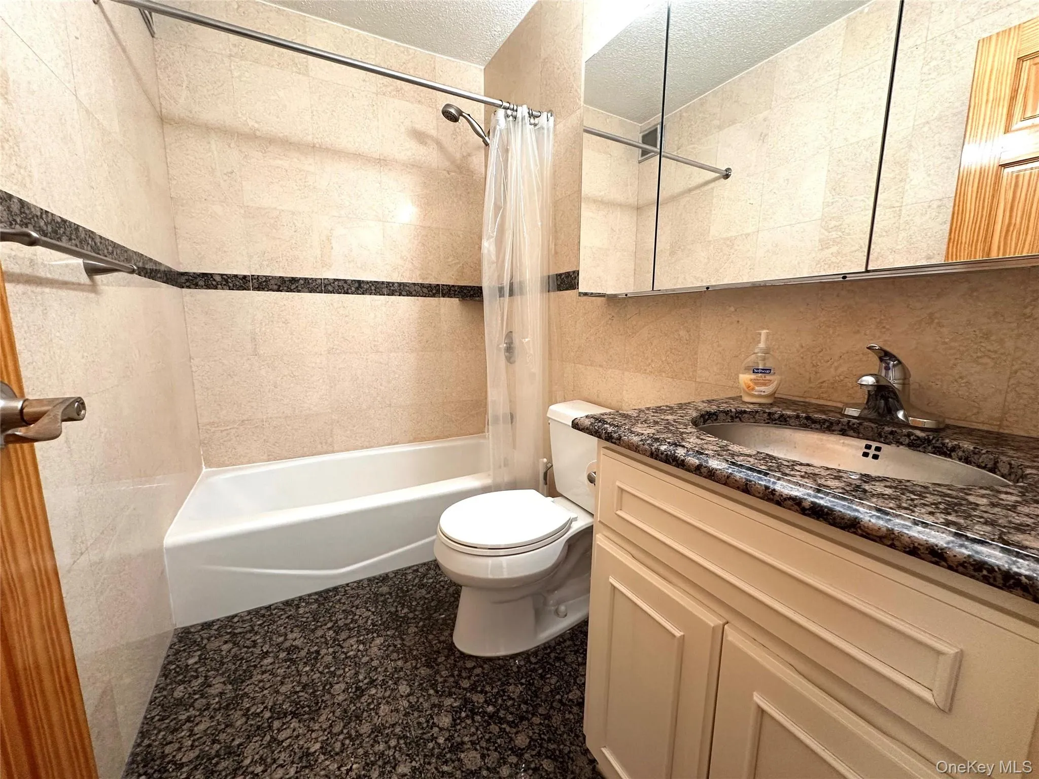 Full bathroom with granite floor and counter Full bathroom with granite floor and counter